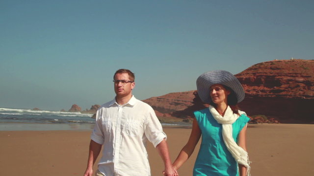 Couple in love walking on the beach, steadicam shot