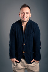 Confident casual man over grey background.