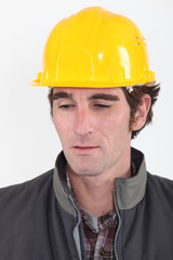 head and shoulders portrait of pensive craftsman