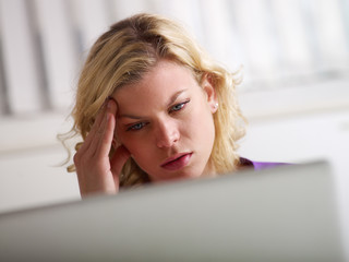 Headache and health problems for young woman at work