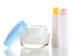 Hygienic lipsticks and moisturizing cream isolated on white