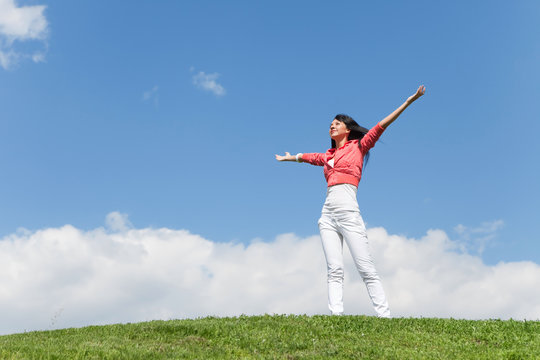 happy young woman dreams to fly on winds
