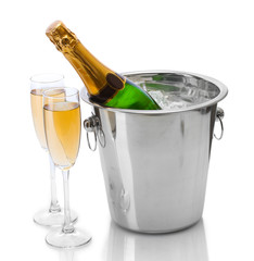 Champagne bottle in bucket with ice and glasses of champagne, © Africa Studio