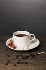 Coffee cup on wooden table on grey background
