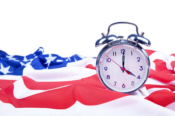 American flag and alarm clock isolated on white