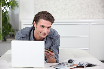 Man using a credit card to buy online