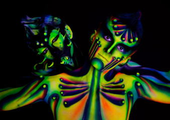 Two men with fluorescent bodyart
