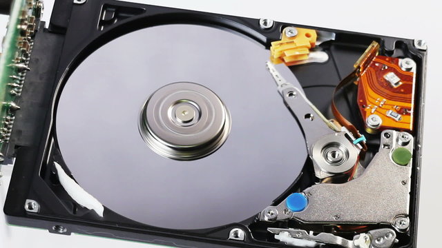 Hard disk drive (hdd) working open with moving head, closeup