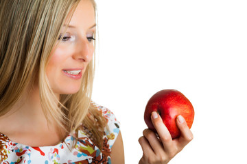 Beauty blond girl with apple isolated on white