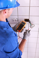 Electrician with a voltmeter