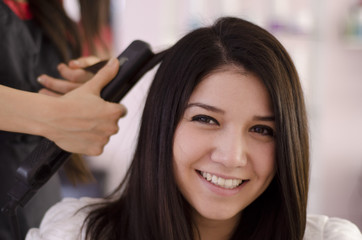 Cute customer getting her hair straightened