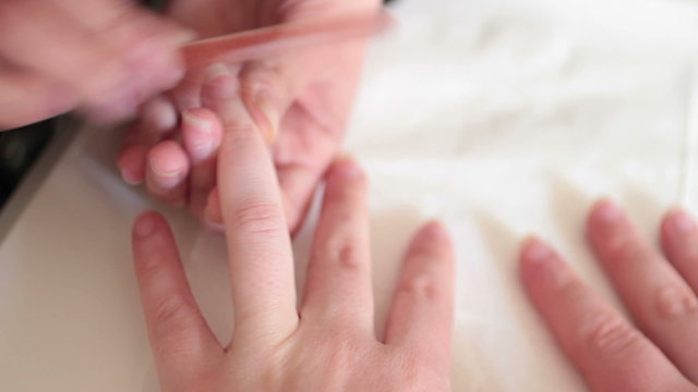Hand holding an emery board