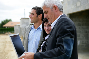 Architect and two potential clients visiting site
