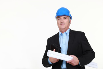Engineer holding a rolled-up blueprint and an agenda
