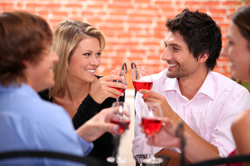 Four friends drinking in restaurant