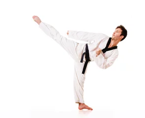 Wall murals Young man practicing martial arts over white background
