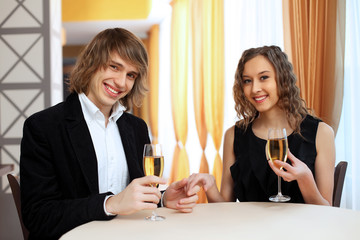 Couple in a restaurant with shampagne