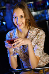 Attractive woman in night club with a drink