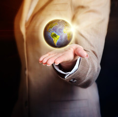 business woman holding earth globe in her hand