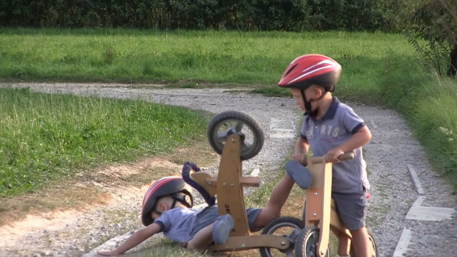 Boys on wooden bicycles, collision