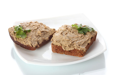 Fototapeta na wymiar Fresh pate on bread on white plate isolated on white