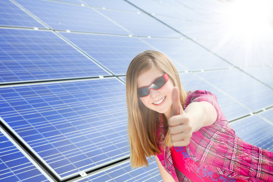 cute girl gives thumbs up for photovoltaic cells