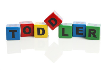 Toddler spelled with alphabet building blocks