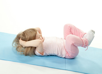 Little girl doing sport exercises