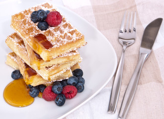 Fresh waffles with fruits and sirup