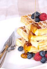 Fresh waffles with fruits and sirup