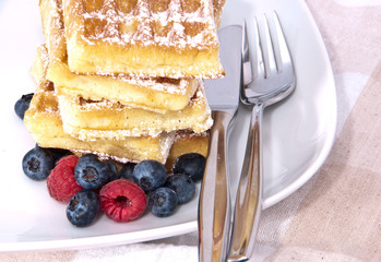 Heap of waffles with fresh fruits
