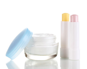 Hygienic lipsticks and moisturizing cream isolated on white