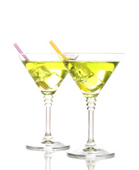 Yellow cocktail in martini glasses isolated on white