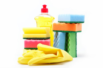 Detergent bottle, rubber gloves and cleaning sponge on a white b