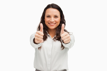 Portrait of a brunette smiling while approving