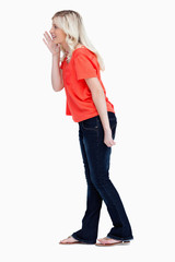 Side view of a teenager girl calling for someone