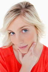 Fototapeta premium Thoughtful young woman looking straight at the camera