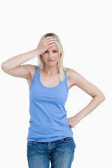 Fototapeta premium Blonde woman placing her hand on her forehead