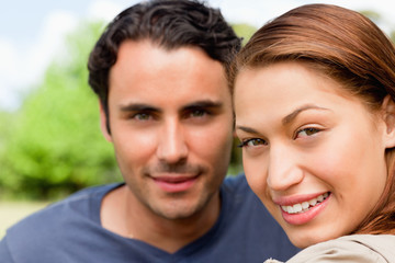 Fototapeta premium Two friends smiling as the look ahead while sitting next to each