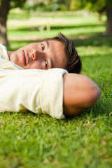 Man with serious expression lying with the side of his head rest