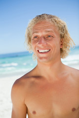 Surprised young blonde man looking towards the side