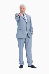 Portrait of a businessman pointing to someone