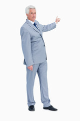 Portrait of a businessman pointing in his back