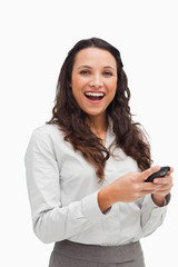 Portrait of a happy brunette looking her text message