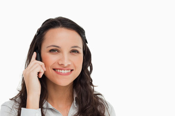 Portrait of a smiling brunette making a call