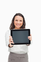 Fototapeta premium Portrait of a brunette showing a touchpad screen