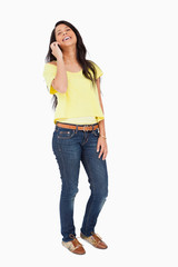Fototapeta premium Beautiful Latin student laughing on the phone