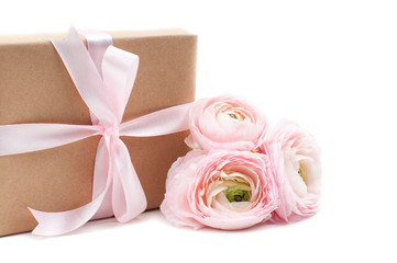 gift tied with ribbon and pink flowers