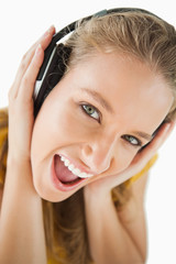 Fototapeta premium Close-up of a blonde student enjoying music with headphones