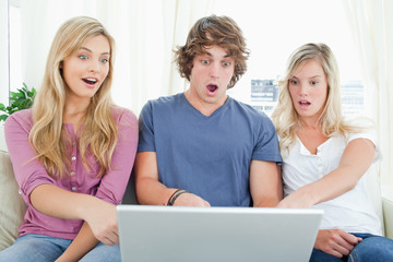 Shocked siblings at what is on the laptop